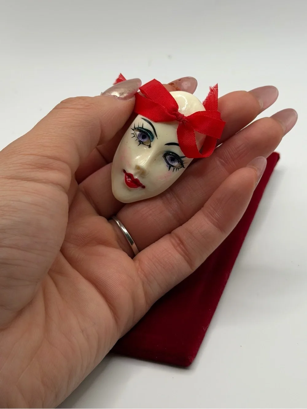 Vintage Face Brooch with Red Ribbon Accent